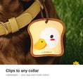 Load image into Gallery viewer, Toast duck charm clipped to a dog collar
